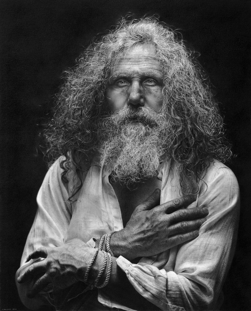 Hyperrealistic drawing of an older man with long curly hair and a beard, hands wrapped in rope, wearing a light shirt against a dark background.